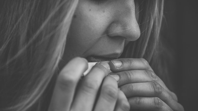 Close-up of woman lighting a cigarette in slow motion