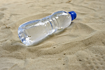 a water bottle in the sand