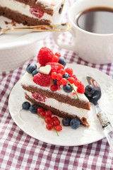 Portion of creamy chocolate cake decorated with fresh berries
