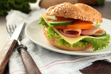 Sandwich with ham and vegetables on a plate