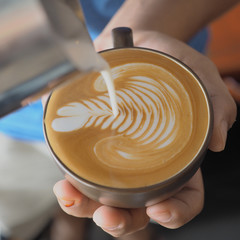 Coffee latte art on the wood vintage desk