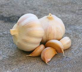 Organic garlic whole and cloves on the wooden background