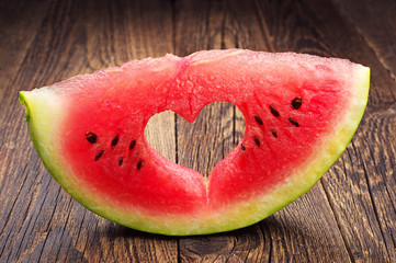 Fototapeta na wymiar Watermelon slice with cut in the shape of heart
