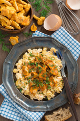 scrambled eggs with chanterelles and fresh dill, vertical