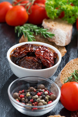 sun-dried tomatoes in a bowl and various appetizers