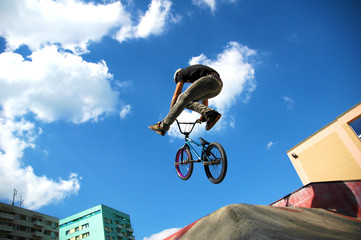 Teenage boy doing tricks on his BMX bike