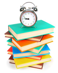 Alarm clock and multi-coloured books.