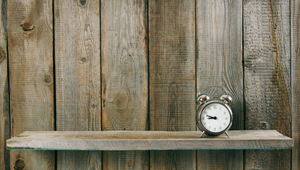 Alarm clock. On wooden background.