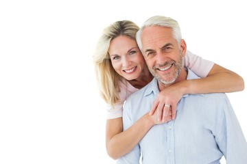 Smiling couple embracing and looking at camera