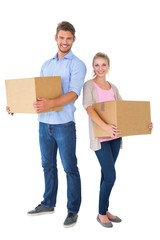 Attractive young couple carrying moving boxes