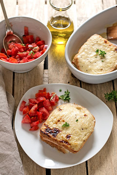 French sandwiches Croque-Monsieur with bechamel sauce and tomato