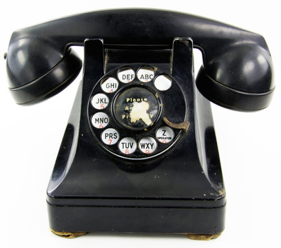A black antique rotary phone on white background.
