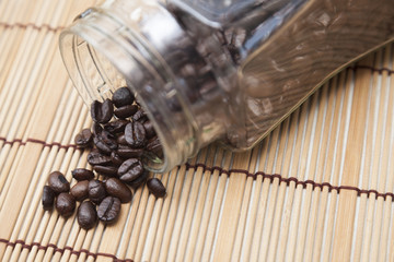 Coffee beans spilled from bottle