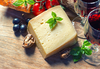 cheese with red wine, walnuts and grapes. food background