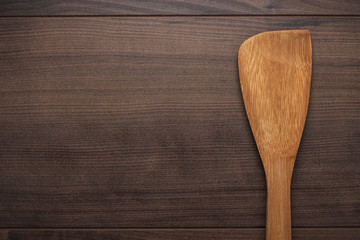 wooden spatula on the brown table