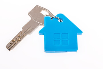 a key with house shaped keyring on white