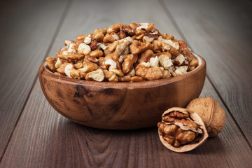 walnuts in the brown wooden bowl