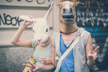 horse and rabbit mask couple of friends young  man and woman