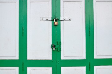 Old Brass Padlock on Wooden Green Gate