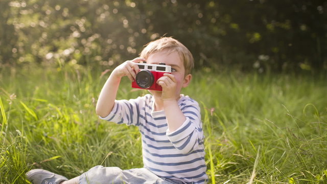 Little Boy Takes Photo of Someone Else