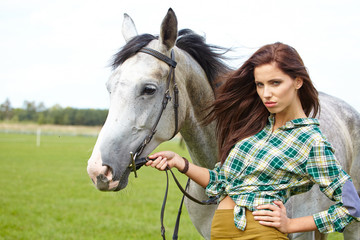 Obraz premium Woman with a white horse