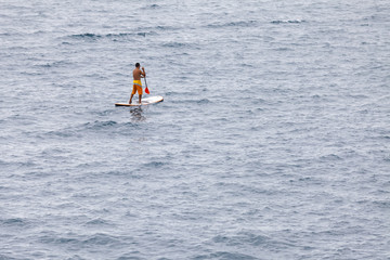 Man floating on a Board in the ocean