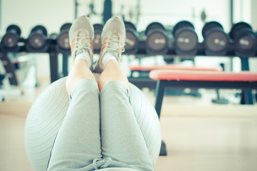 Woman legs of exercises in the gym.