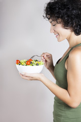 Young woman profile with vegetable salad isolated