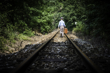 Fototapeta premium Child walking on railway
