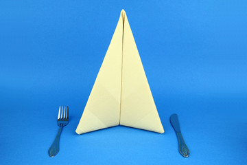 Folded napkin on the blue background