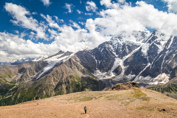 one man standing among mountains