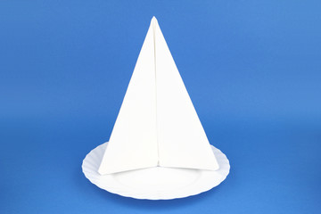 Folded napkin on the white plate