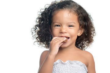 Little girl with an afro hairstyle eating a chocolate cookie