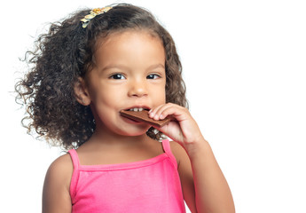 Little girl with an afro hairstyle eating a chocolate cookie