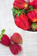 strawberries in a bowl and scattered