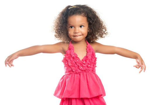 Lttle girl with an afro hairstyle with her arms extended