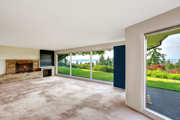 Spacious empty living room with walkout basement overlooking bea