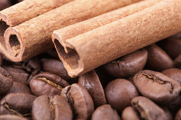 Roasted coffee beans background with cinnamon