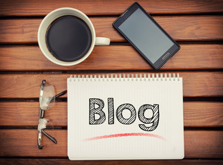 Notebook with text Blog inside on table with coffee