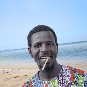 African man holding a miswak (traditional teeth cleaning twig)