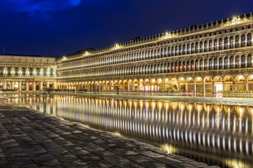 Fototapeta na wymiar San Marco square with reflection on water at night, Venice.