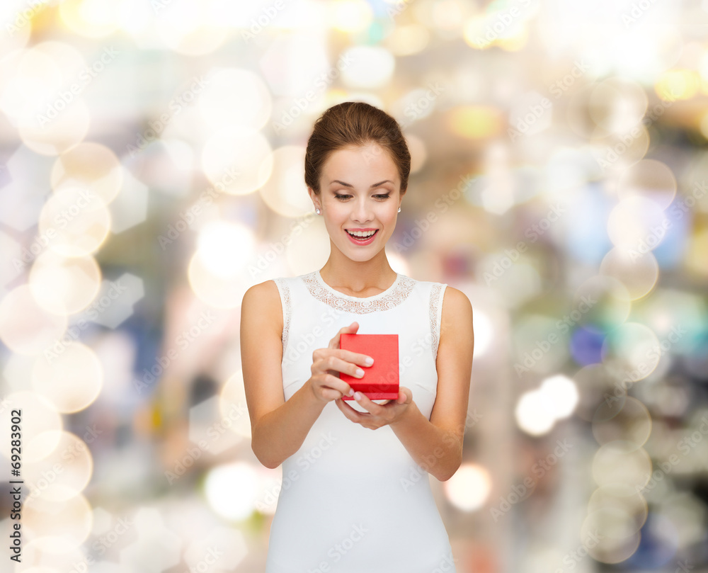 Wall mural smiling woman holding red gift box