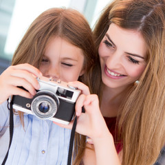 Girl shooting with a vintage camera