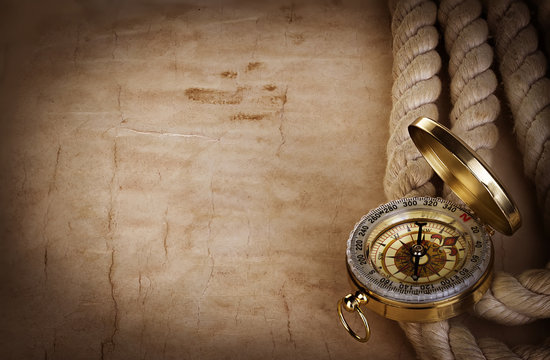 Compass and rope on the old paper background
