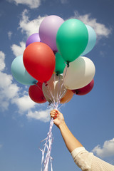 Woman hand with colorful balloons