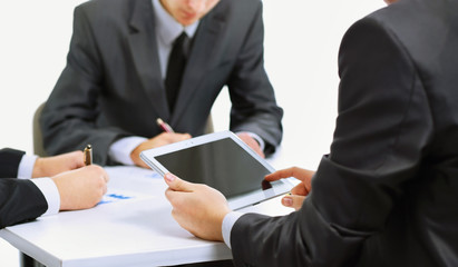 Close-up of a modern business team using tablet computer to work