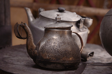 old teapot and kettle in a kyrgyz yurt kitchen, shallow dof