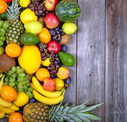 Huge group of fresh colorful fruit on wooden background - Health