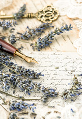 vintage ink pen, key, lavender flowers and old love letters