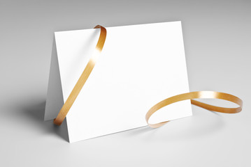 Blank card with golden ribbon